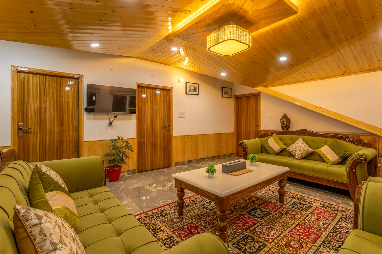 Second living room with a wall-mounted television and doors leading to the bedrooms