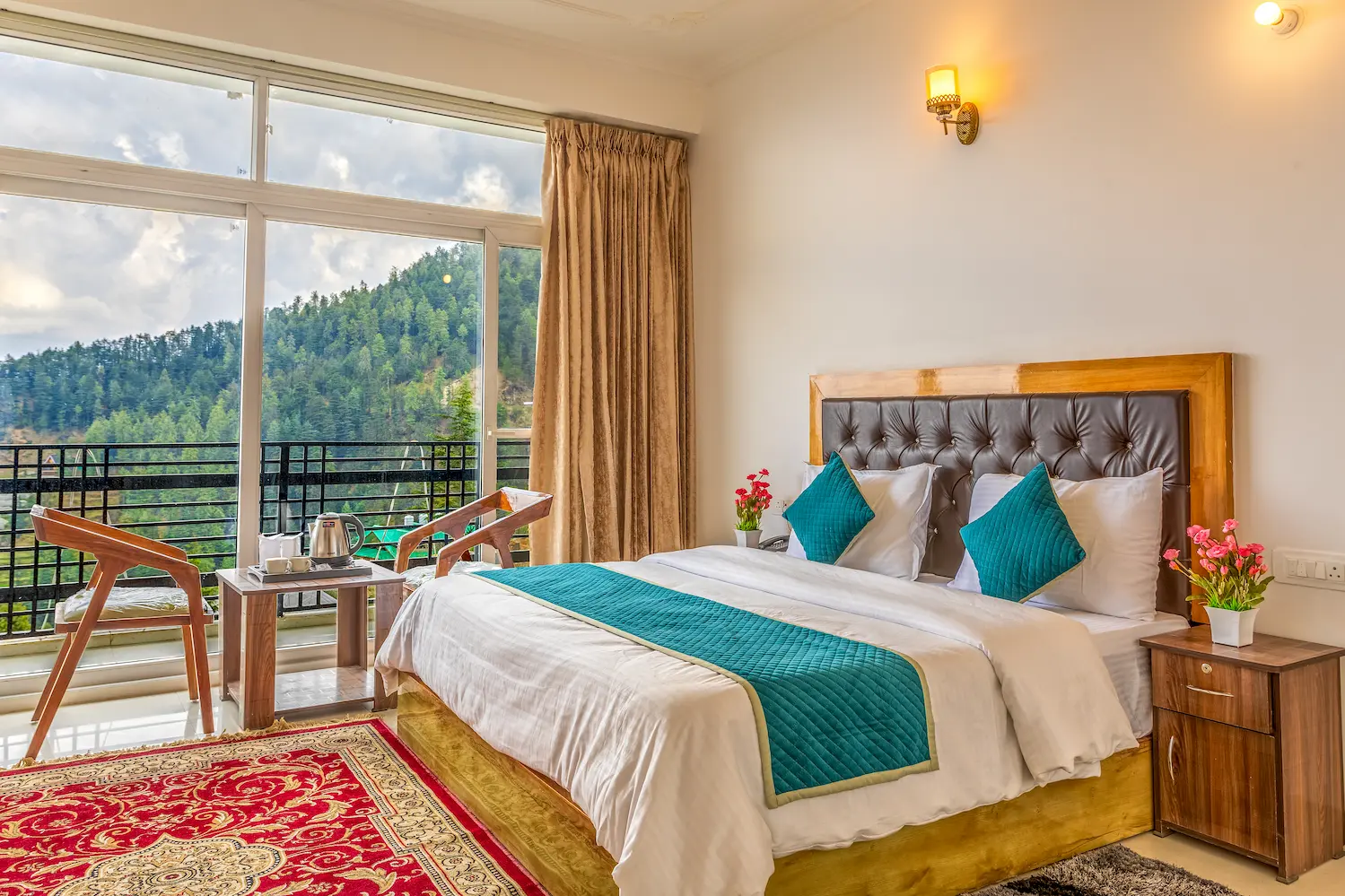 Balcony bedroom with a tea tray set out beside the window and deodars beyond