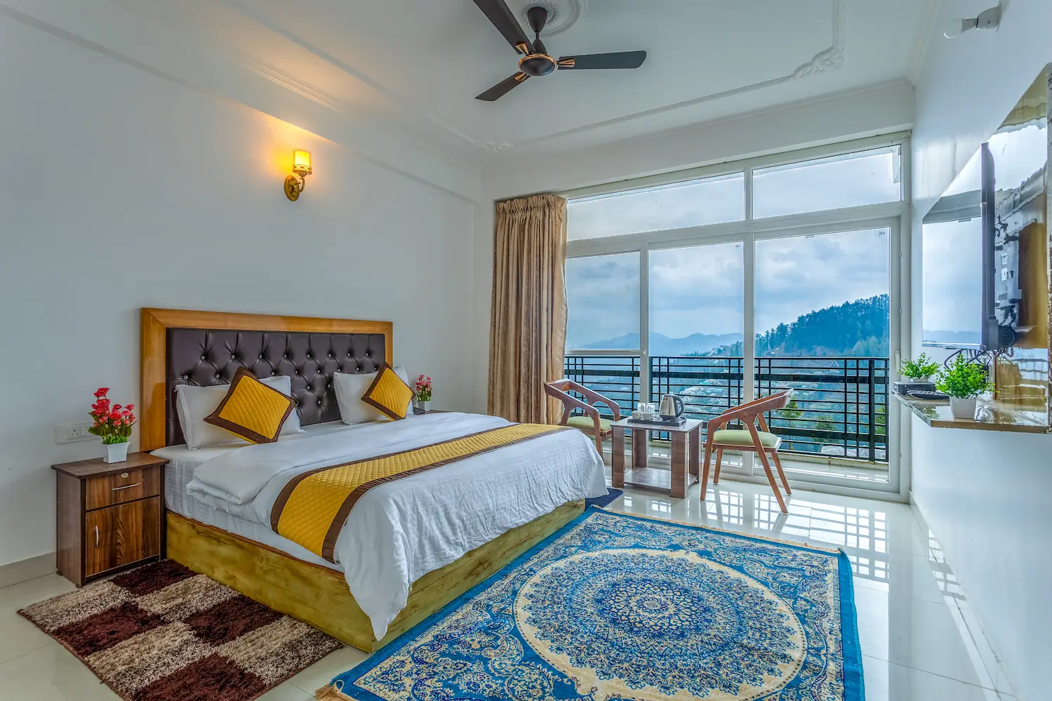 Bedroom in white and gold with a balcony over the deodar forest