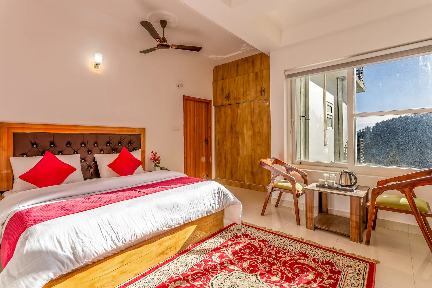 Guest room with a full wardrobe and tea table by the window