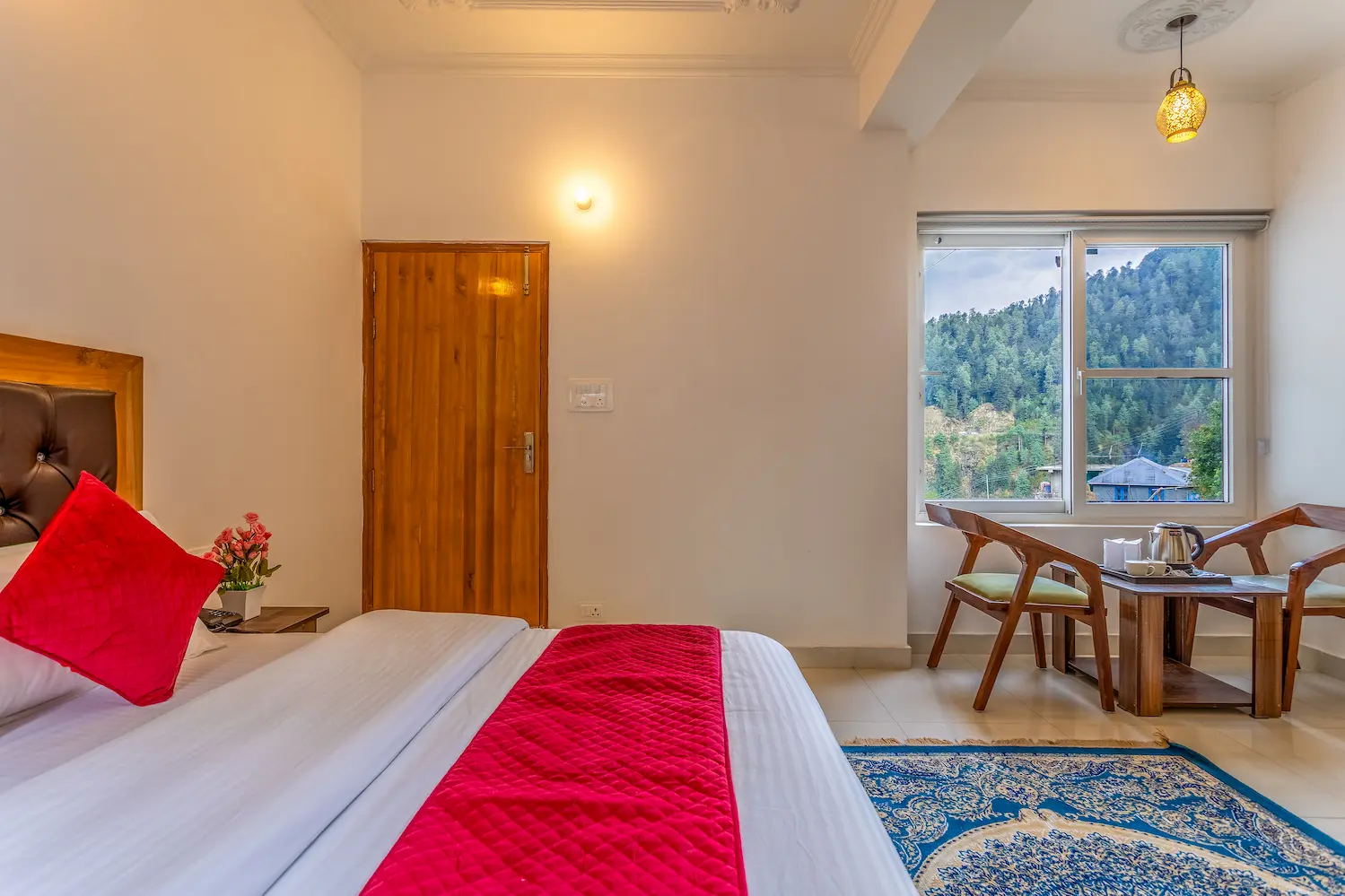 Cozy double room with a window seat looking onto the pine slope