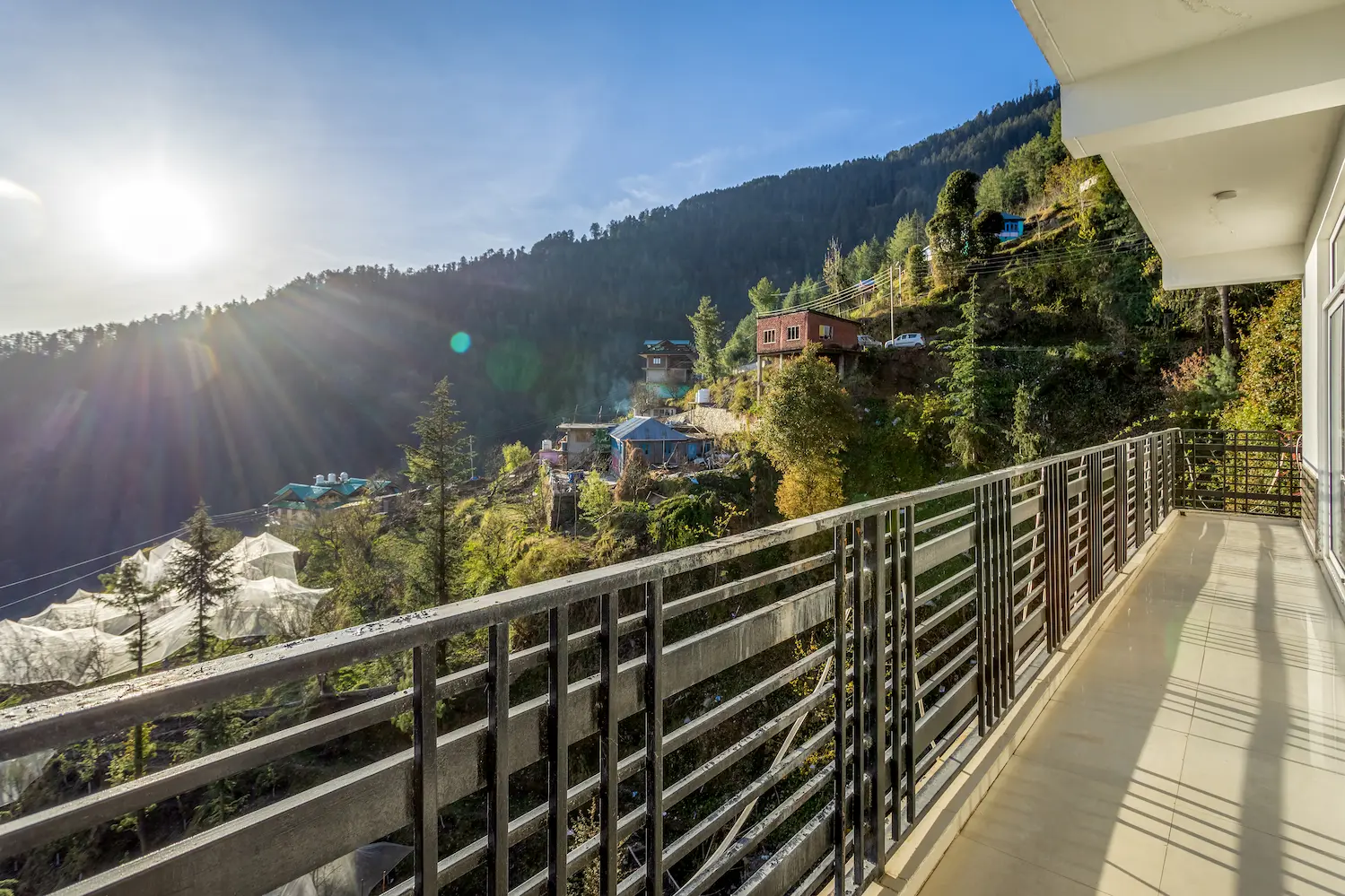 Morning sun breaking over the ridge, seen from the villa balcony