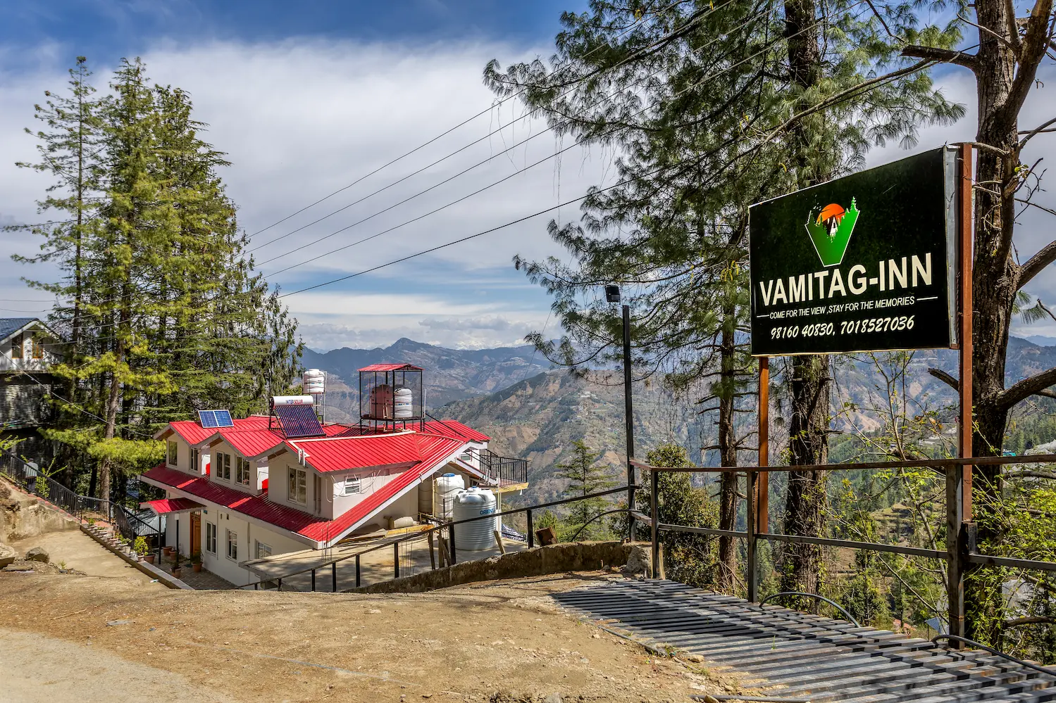 The red-roofed villa and its entrance drive, with the VAMITAG Inn signboard at the roadside