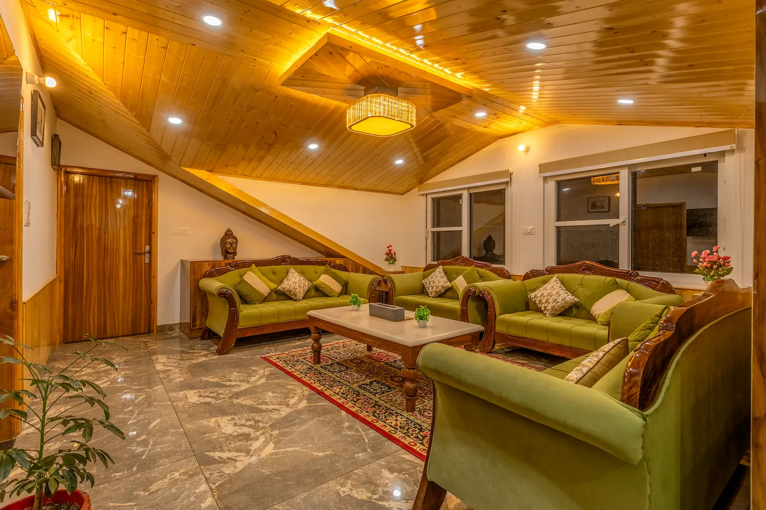 The attic living room from the doorway, lit warmly under its wood-panelled gable